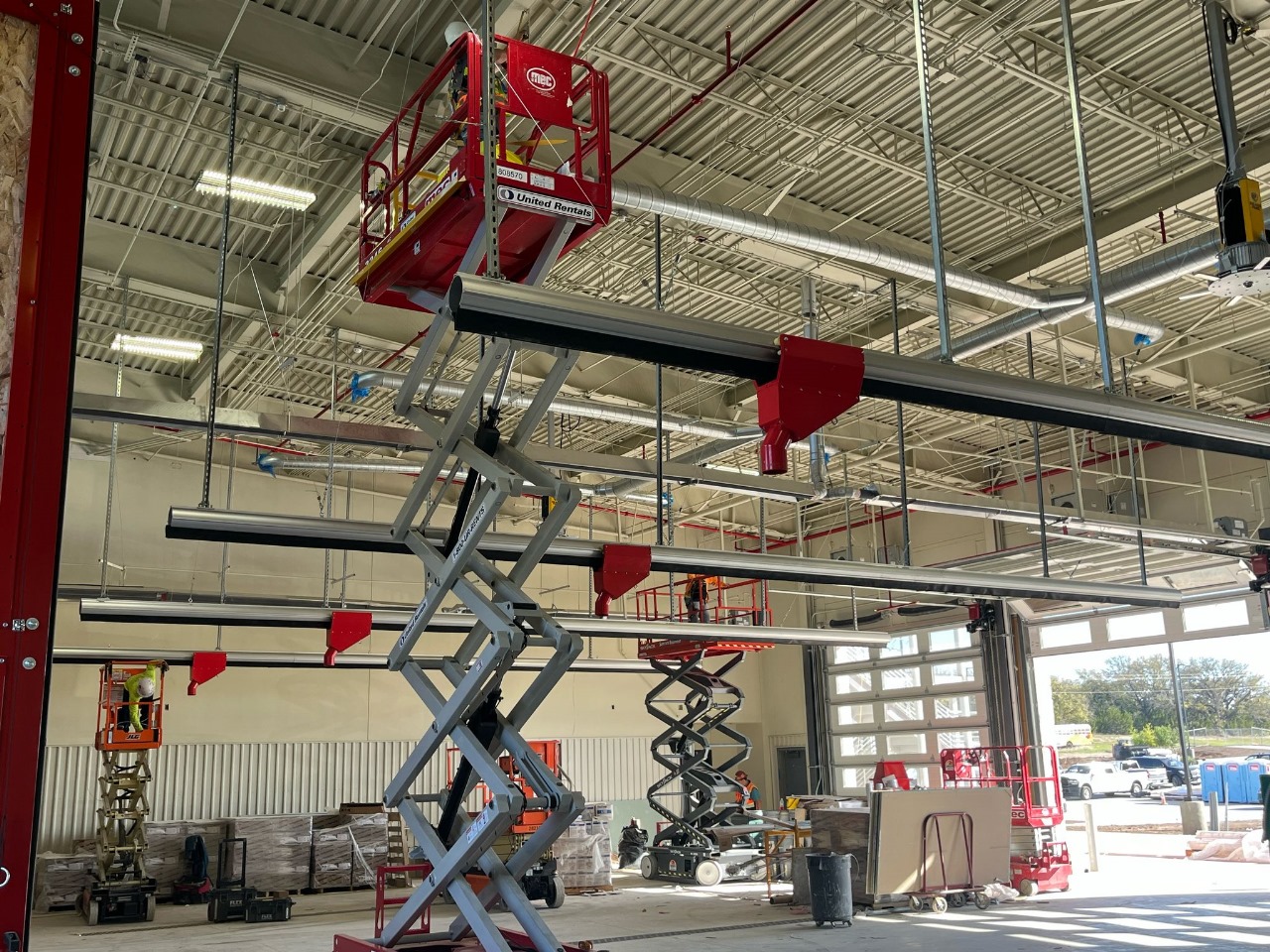 Multiple FIRERAIL exhaust rails being installed across fire station bays in Killeen, Texas.
