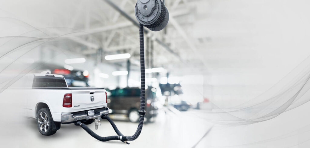 Telescoping fume extraction arm positioned over welding station in Texas workshop